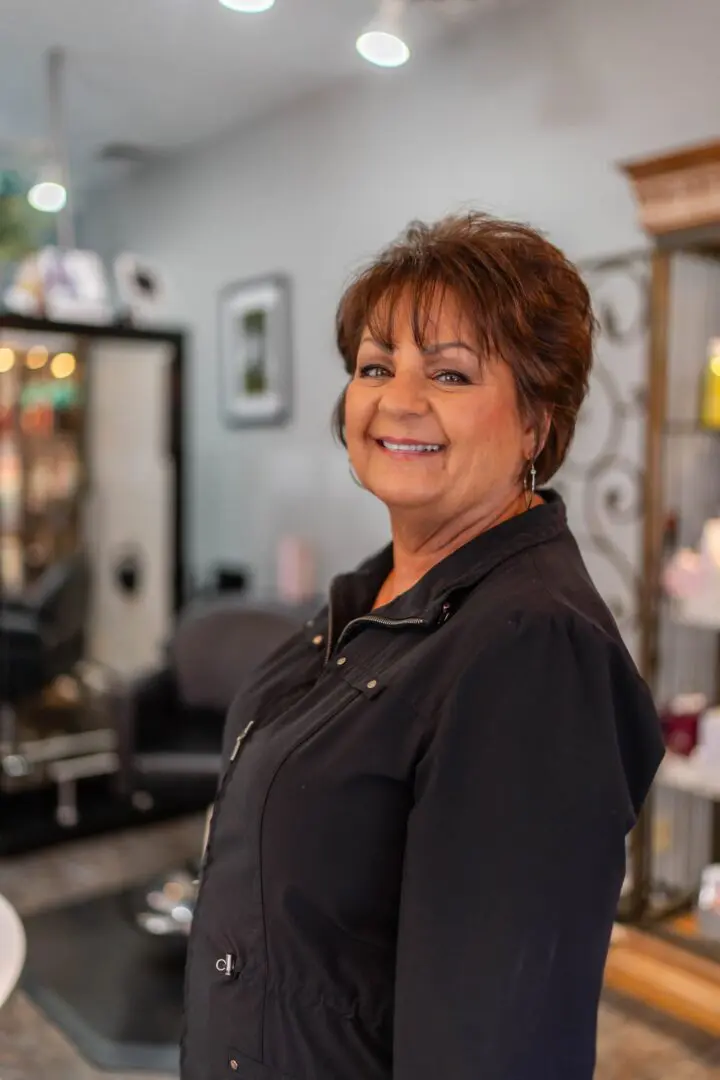 Smiling woman in a salon setting.